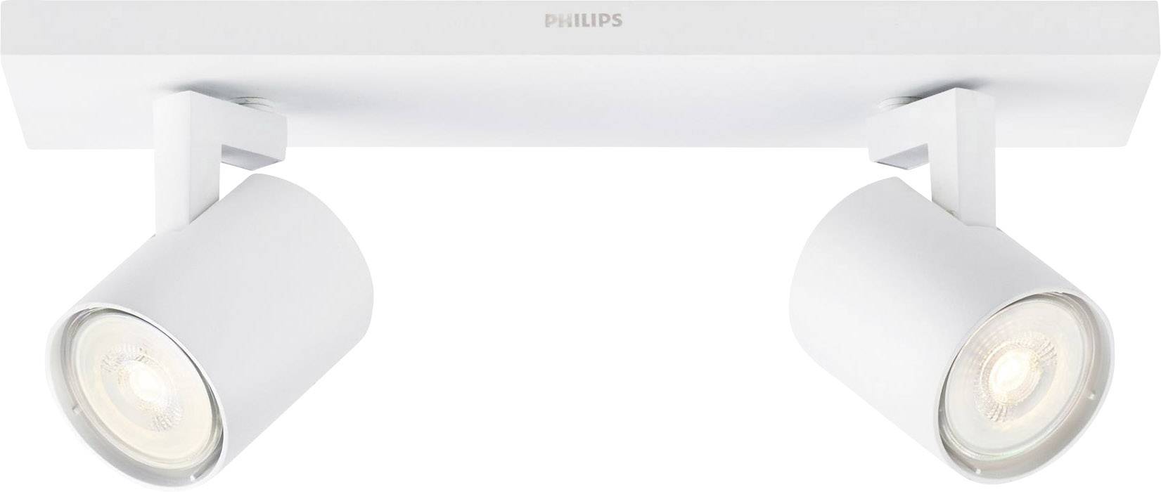 Two white, cylindrical ceiling spotlights by Philips, mounted on a rectangular base, are illuminating in different directions.