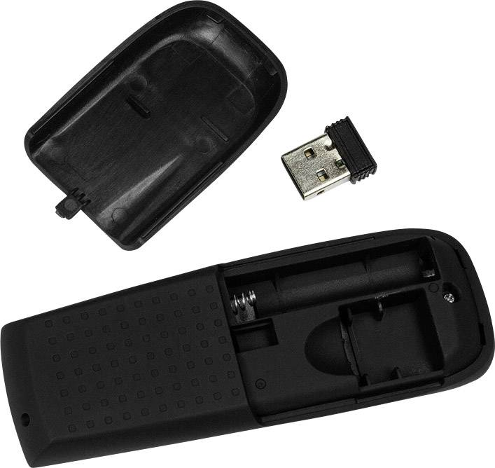 Black remote control, open back revealing battery compartment and USB receiver lying beside it.