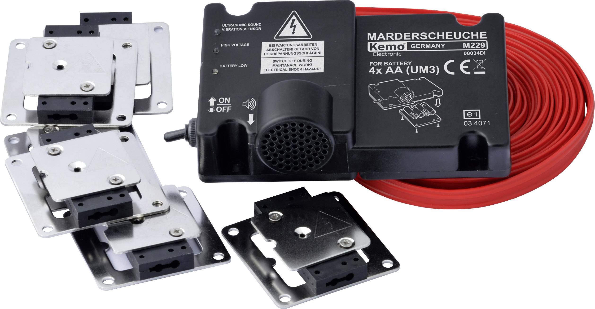Electronic device with cables and metal plates, labelled 'Marten Deterrent', for scaring away martens from vehicles.