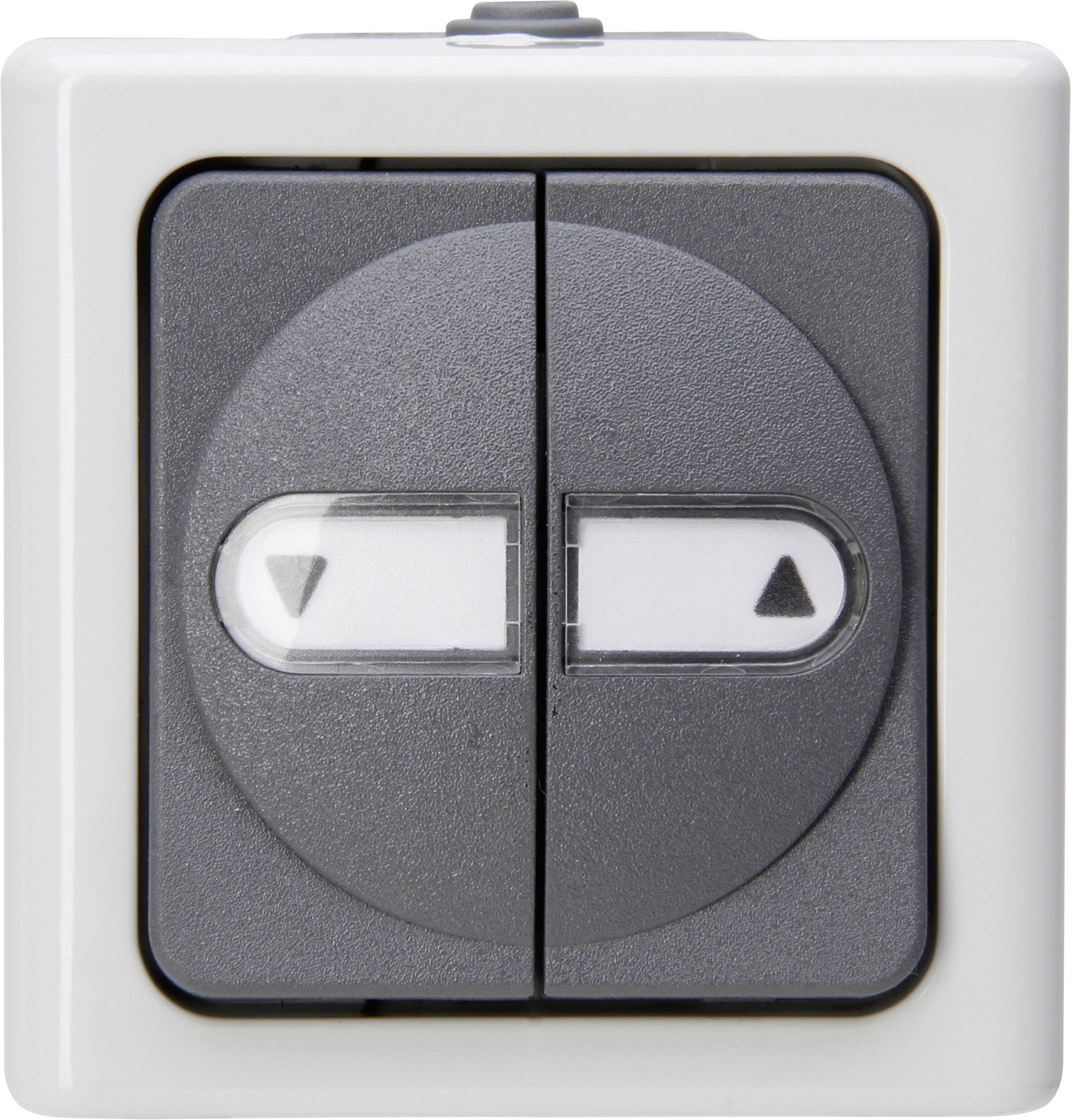 A square double light switch on a white wall, with two black buttons, each featuring a triangular symbol.