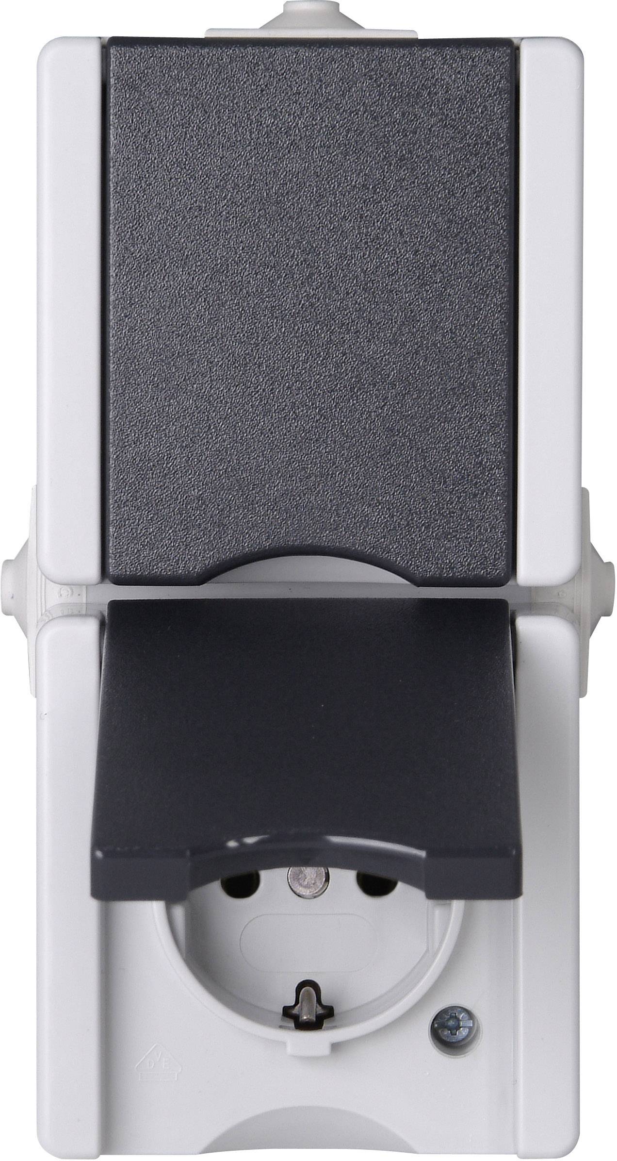 The image shows a white socket with a black cover. The flap is open, revealing the plug connection.