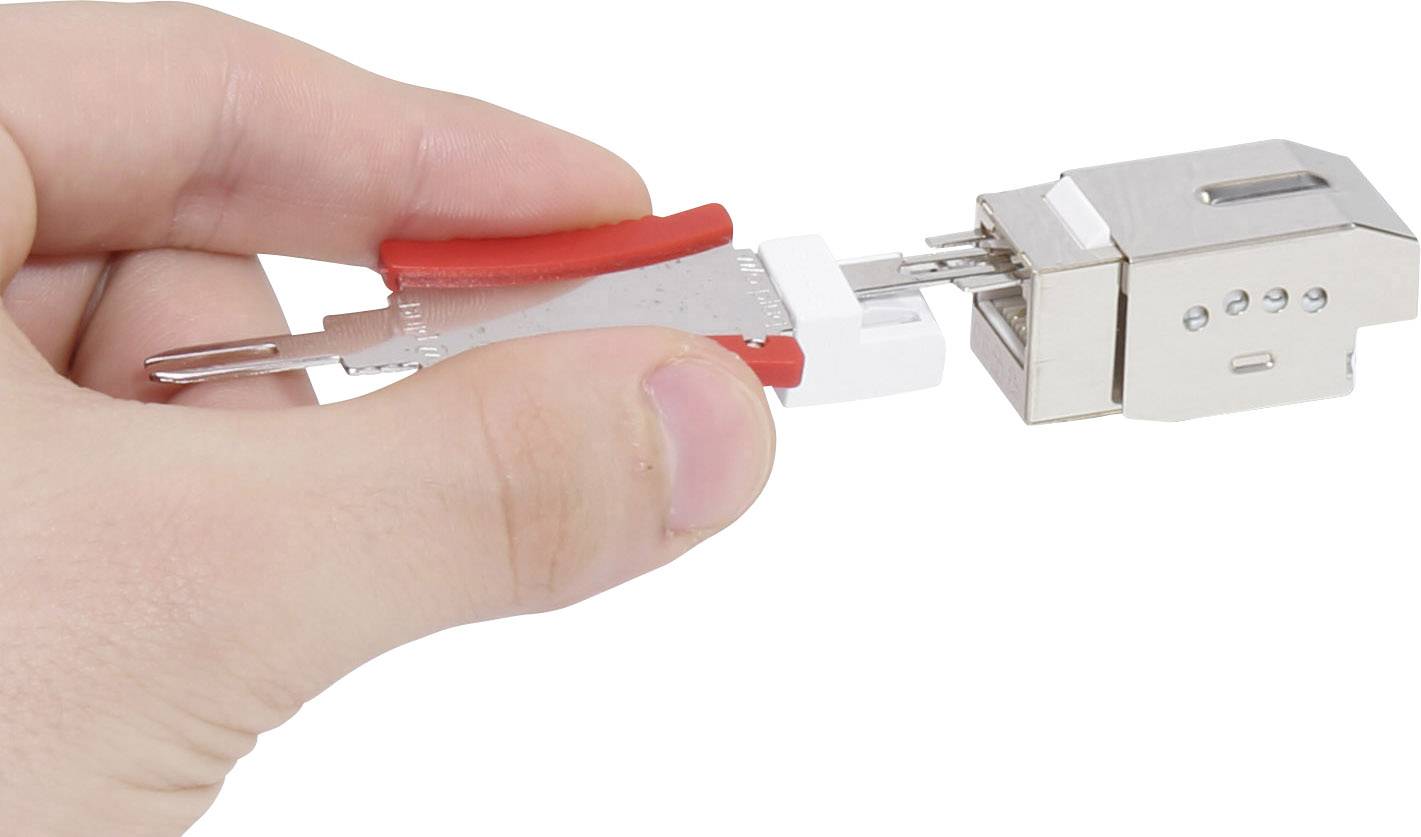 Close-up of a hand holding a metallic tool being inserted into a technical component, possibly for repair or assembly.