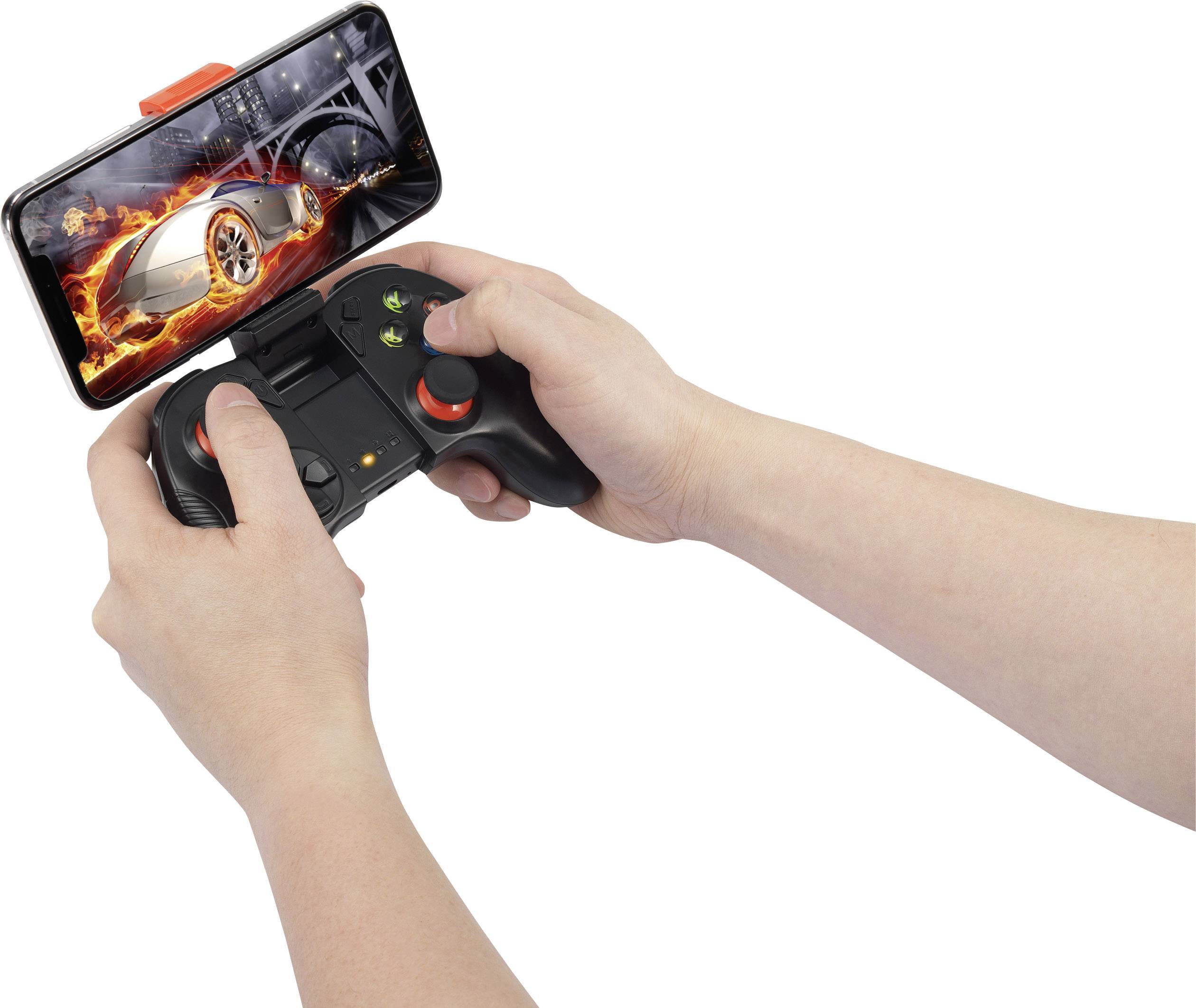 A person is holding a game controller. A smartphone is attached to it, displaying a car racing game with a fast car.