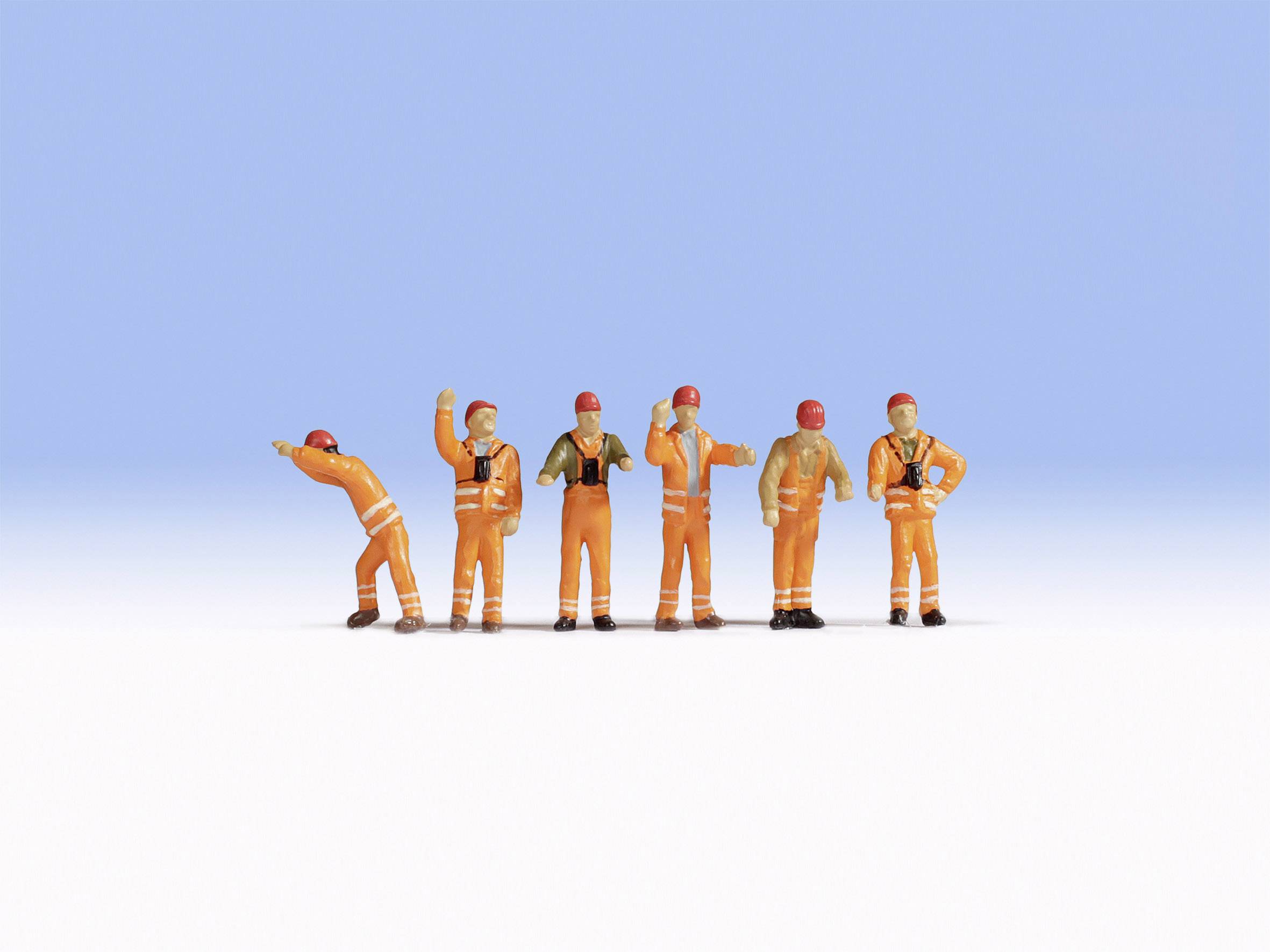 Six miniature figures in orange overalls and hard hats stand in front of a blue background, as if working on a building site.