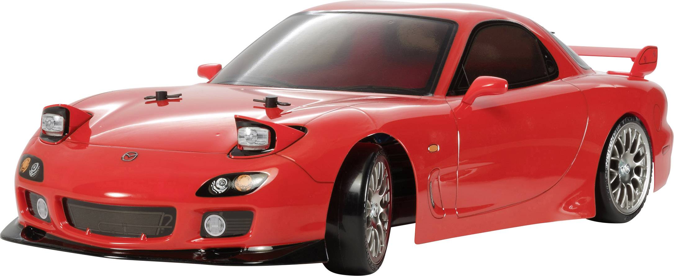 Red toy car at 1:10 scale, based on a sports car model, with an open driver's window and visible details.