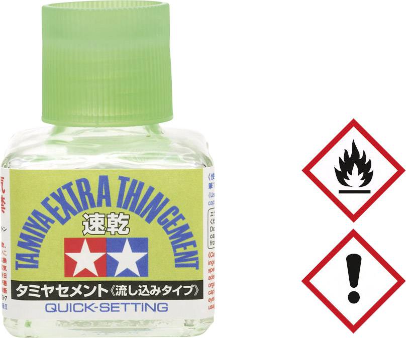 Bottle of Tamiya Extra Thin Cement, Quick-Setting, with green cap; Warning symbols: Flammable and Hazardous. Suitable for model-making.