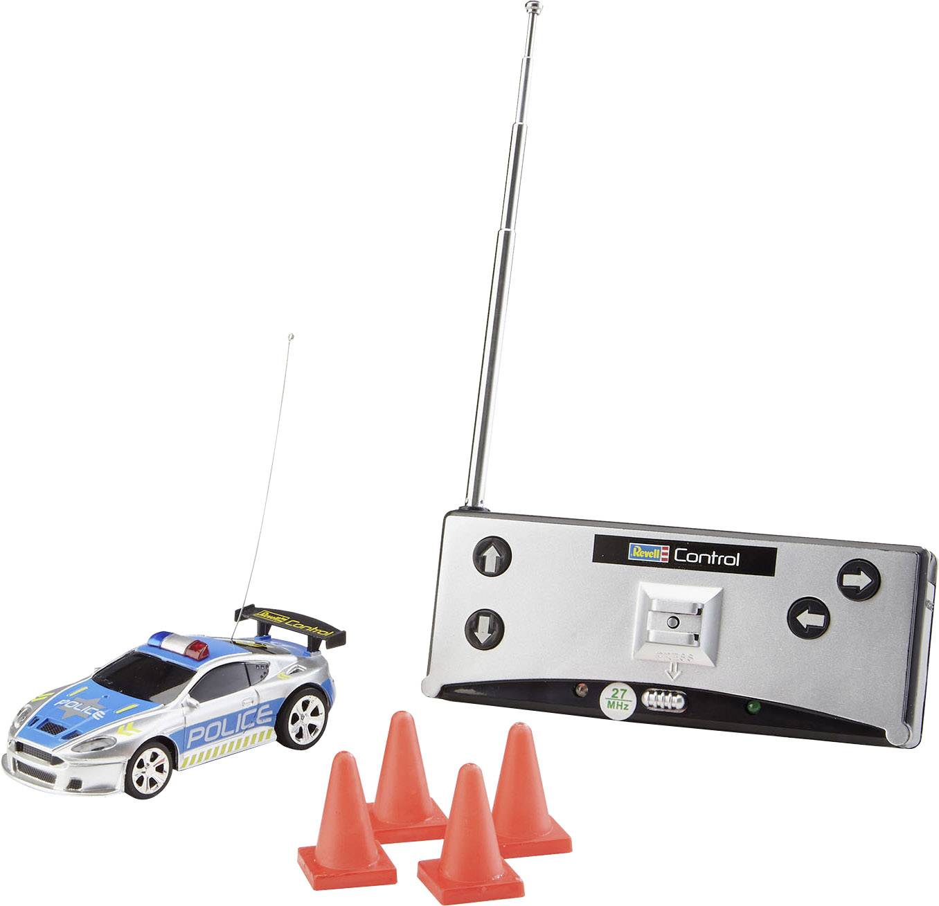 Remote-controlled police car with remote control and three red cones. Car has blue emergency light and aerial.