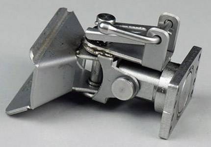 Metal hinge used for connecting furniture components. Detailed view reveals screw mechanisms and movable parts.