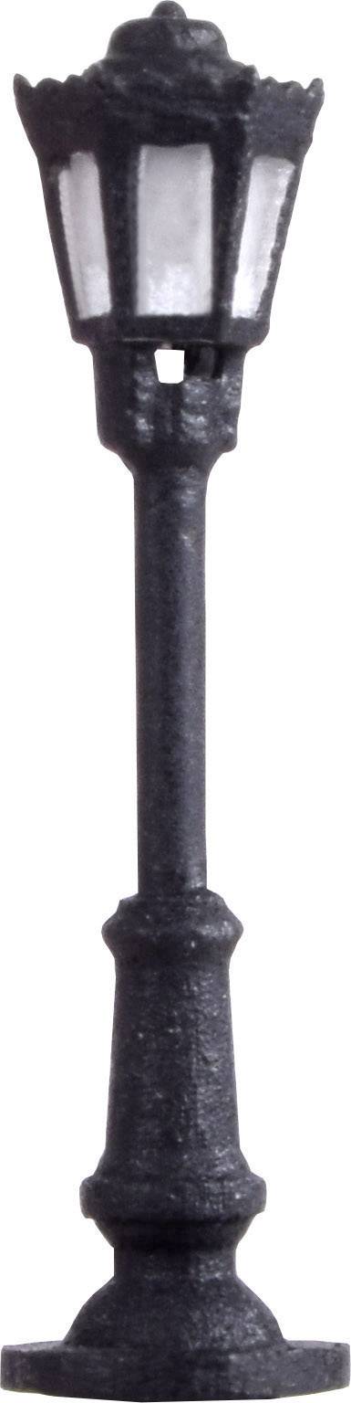 A cast-iron street lamp with a hexagonal lampshade, mounted on a base. It looks decorative.