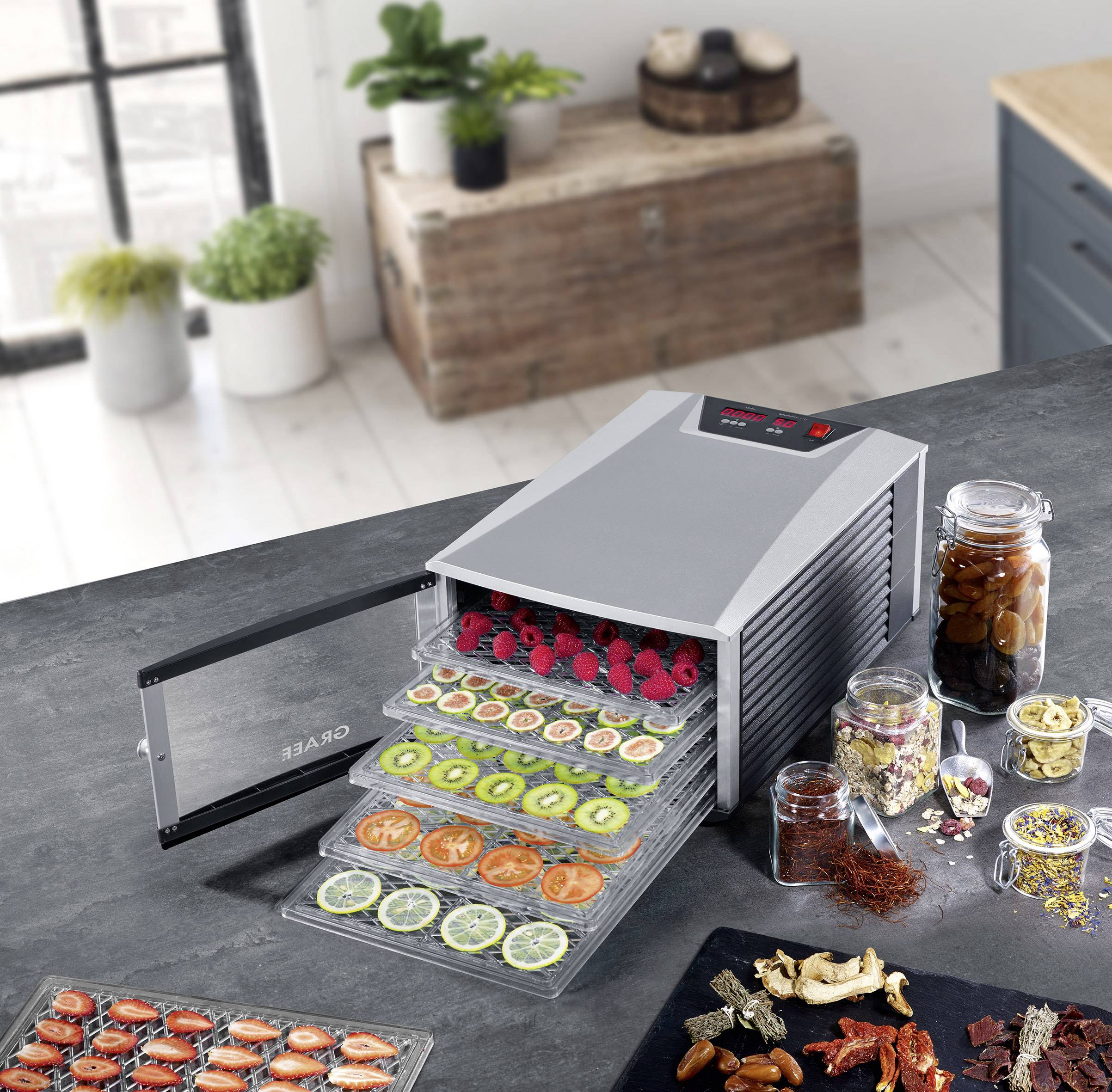 Food leftovers and fresh fruit and vegetables are dried in a horizontal food dehydrator. Various ingredients are arranged on multiple trays.