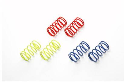 Red, yellow, and blue spiral springs on a white background, evenly arranged, demonstrate diversity in shapes and colours.