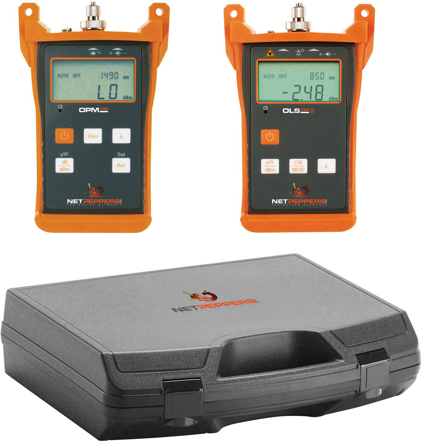 Two orange network testers lying on a black case. The devices are displaying measurement values on their screens.