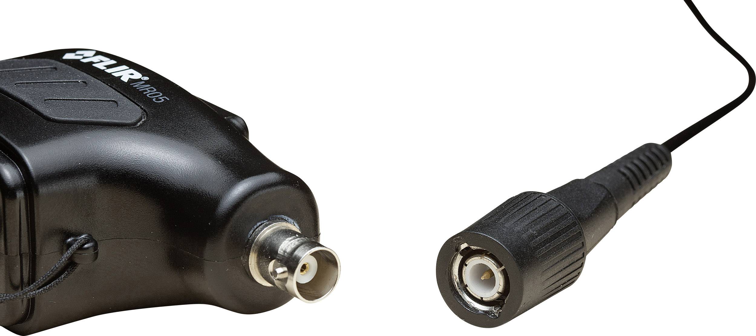 A black cable with a coaxial plug is connected to an electronic device visible on the left side of the image.