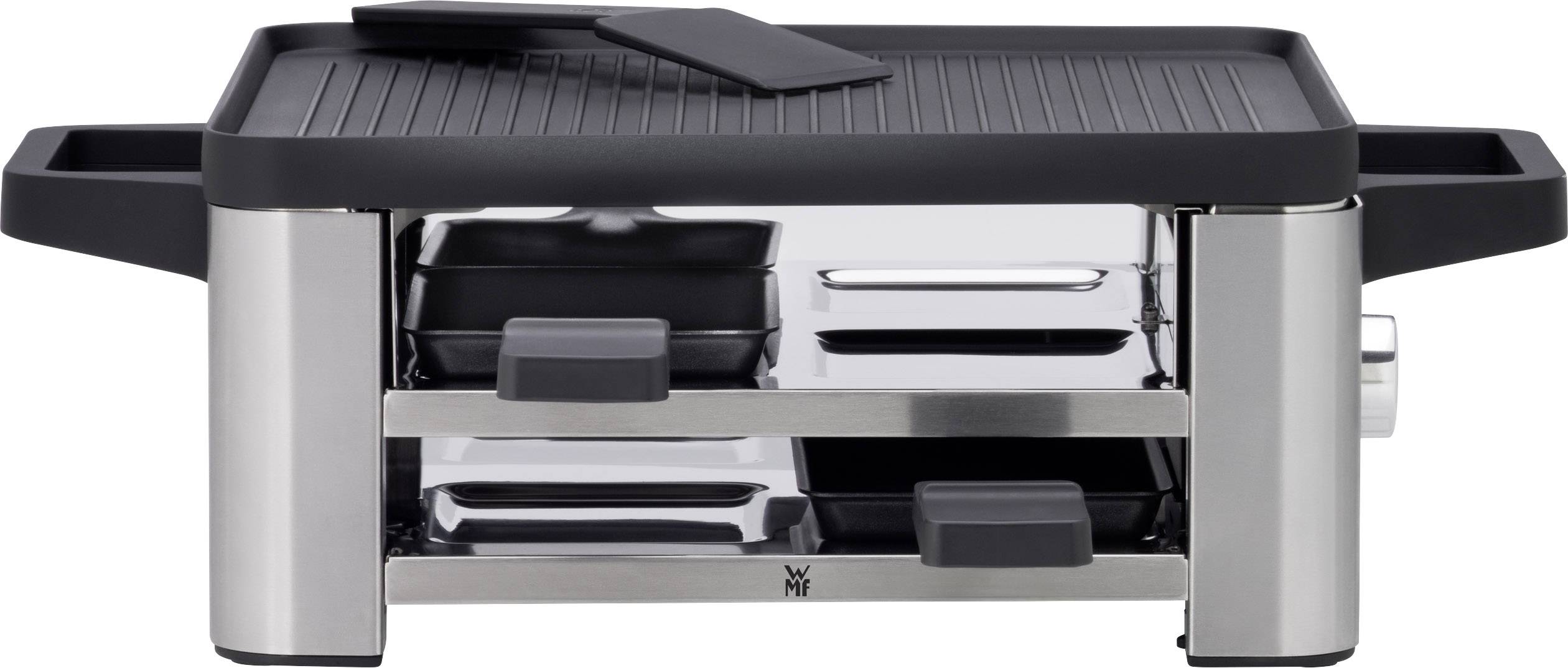Raclette grill with metal casing, two black handles, a ridged grilling surface and underlying drawers for small pans.