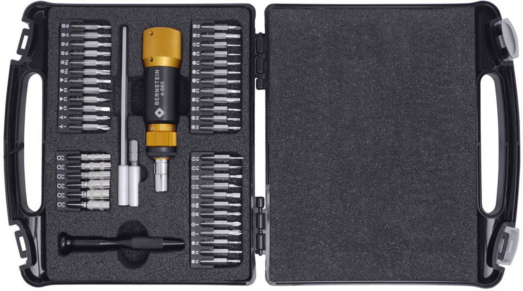 A screwdriver set with various bits and handles in an open black case.