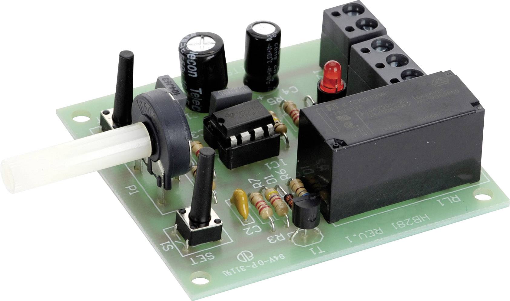Electronic circuit board with various components: relays, capacitors, resistors, and LEDs on a green printed circuit board.