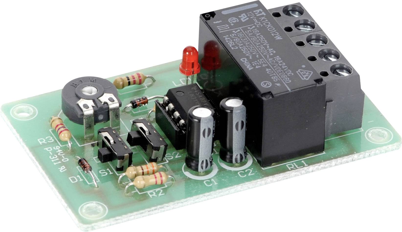A green printed circuit board with electronic components such as resistors, capacitors and a black relay on the right-hand side.