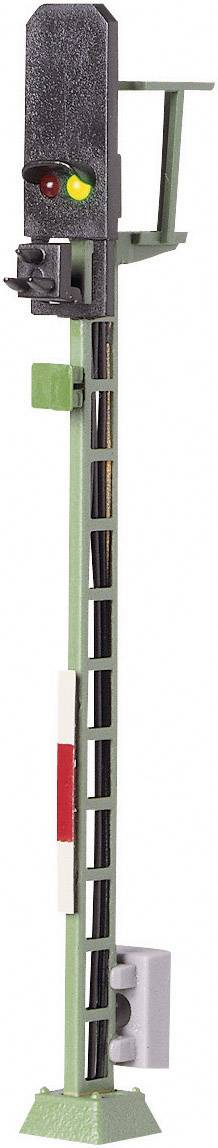 A model railway signal with three lights: red stop signal, yellow caution signal, and green proceed signal.