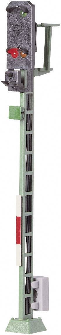 Model of a railway signal light with red and orange illuminated lights, mounted on a green post.