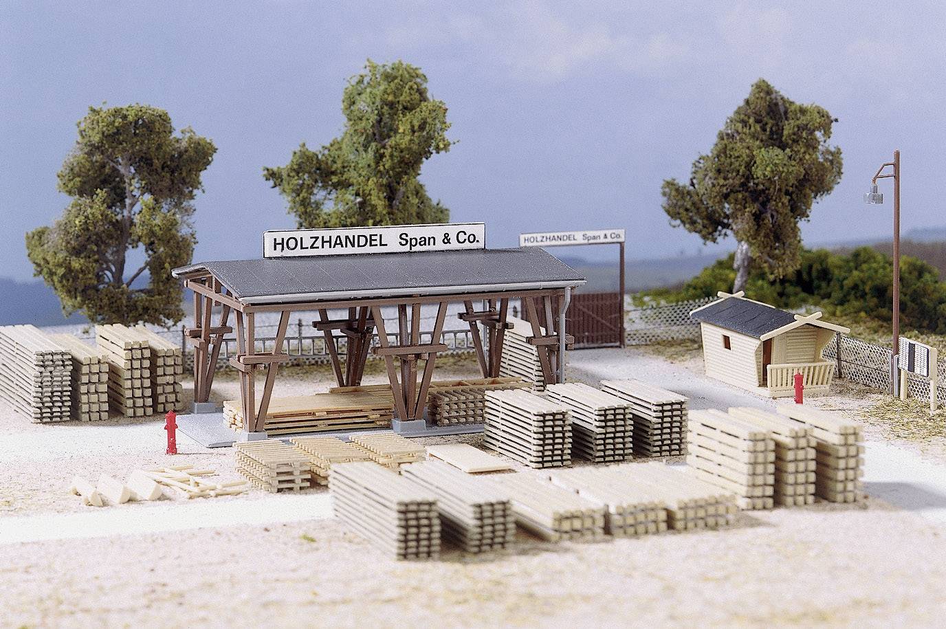 A timber merchant with the company sign 'Timber Merchants Span & Co.'. Stacks of wooden planks are neatly arranged. Trees are visible in the background.
