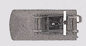 Top-down view of a skateboard deck with a silver motor module and black mounting bracket.