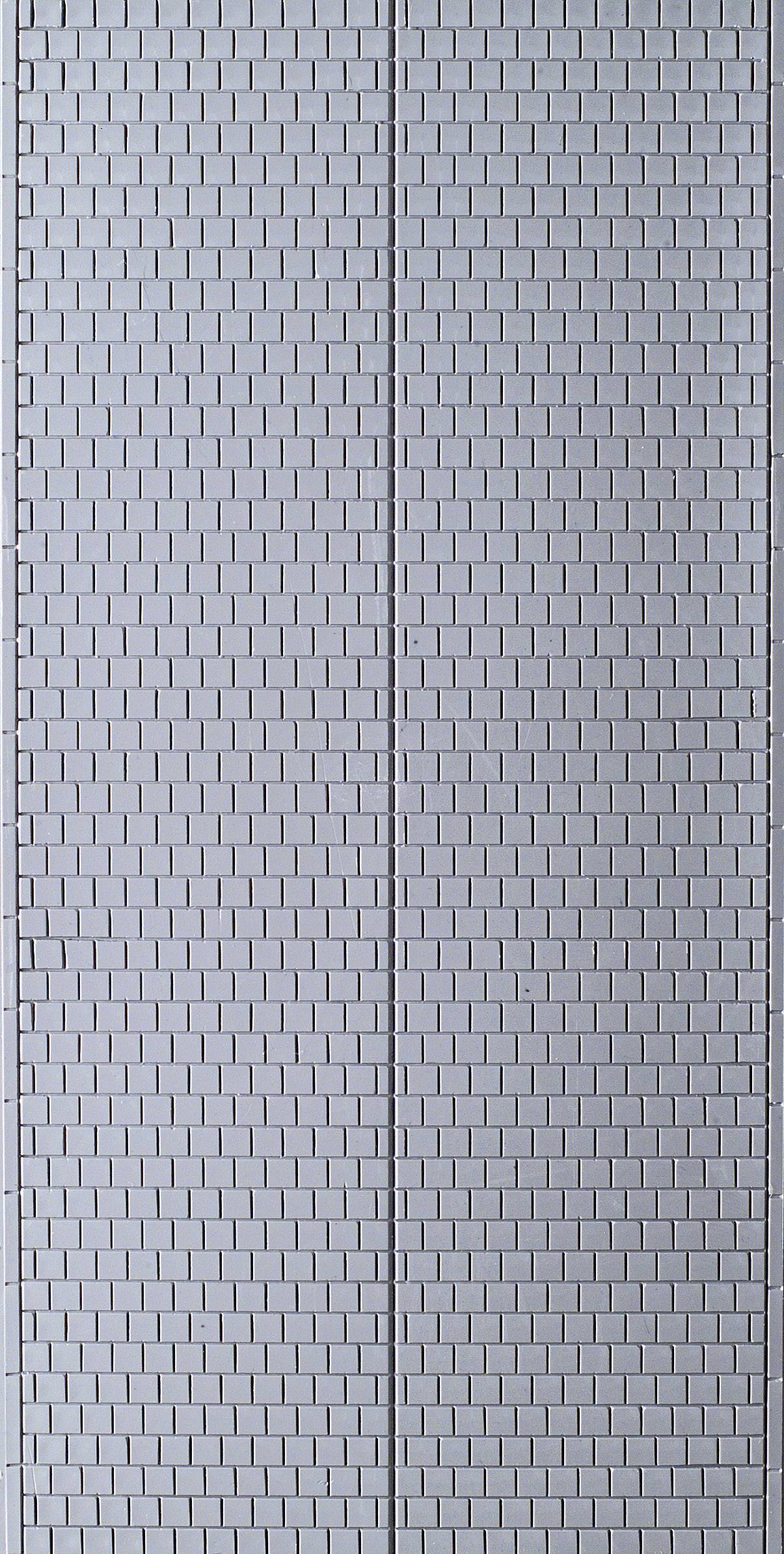A grey brick wall with a symmetrical pattern of small rectangular bricks.