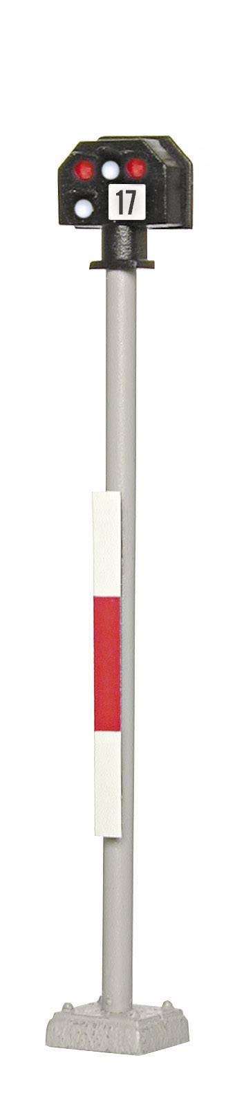 Railway signal with the number '17' and three lights: two red, one white. Standing on a grey post with a white-red sign.