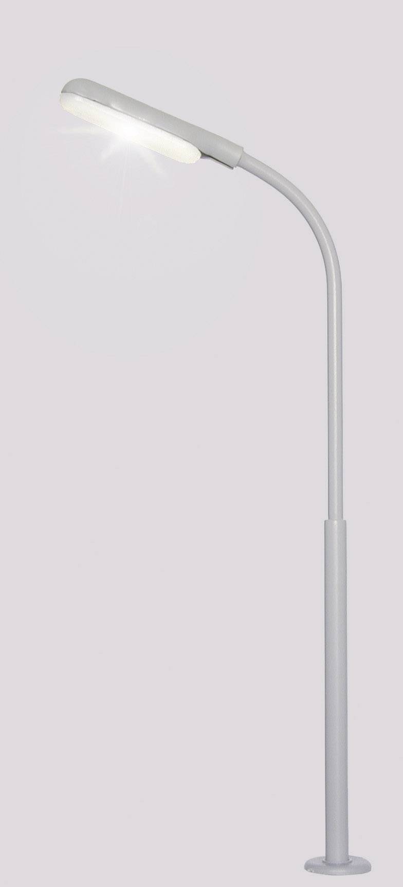 Grey, modern floor lamp with a curved arm, casting bright light downwards.