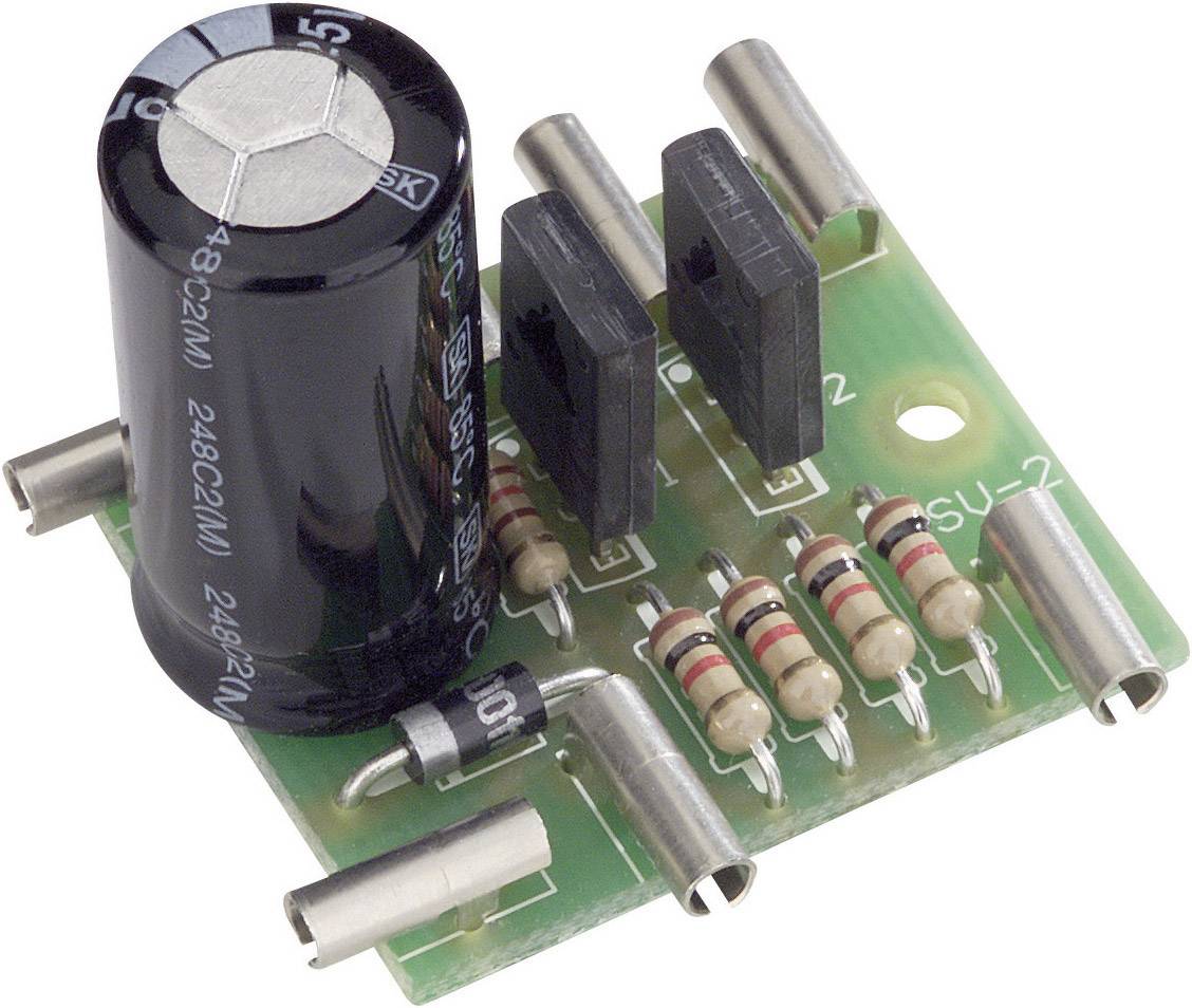 Electronic circuit board with a large capacitor, several resistors and connections on a green printed circuit board material.