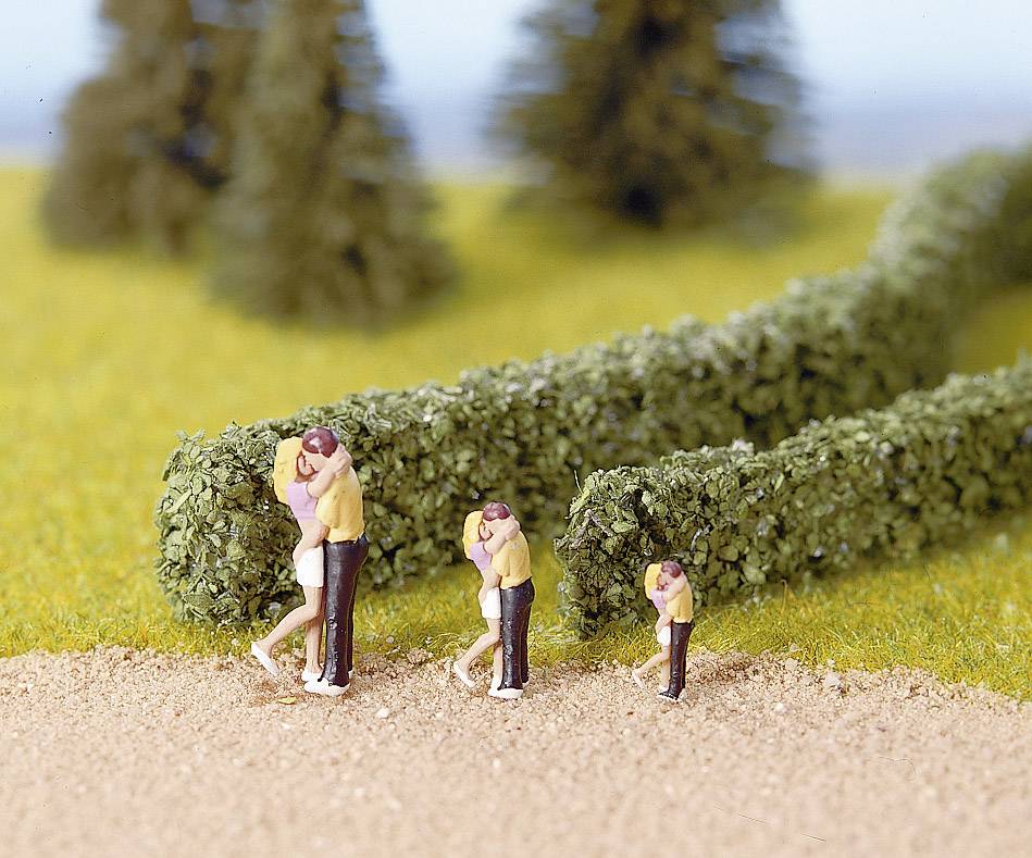 Miniature model of four couples embracing, positioned on a path with hedges and a grassy background.