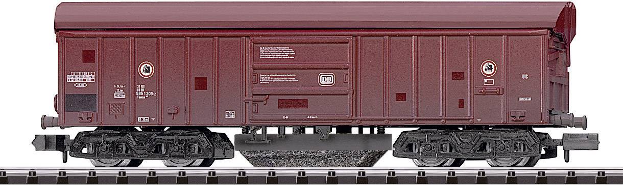 A brown goods wagon on rails, side view, shows clear lines and details, suitable for model railway representations.