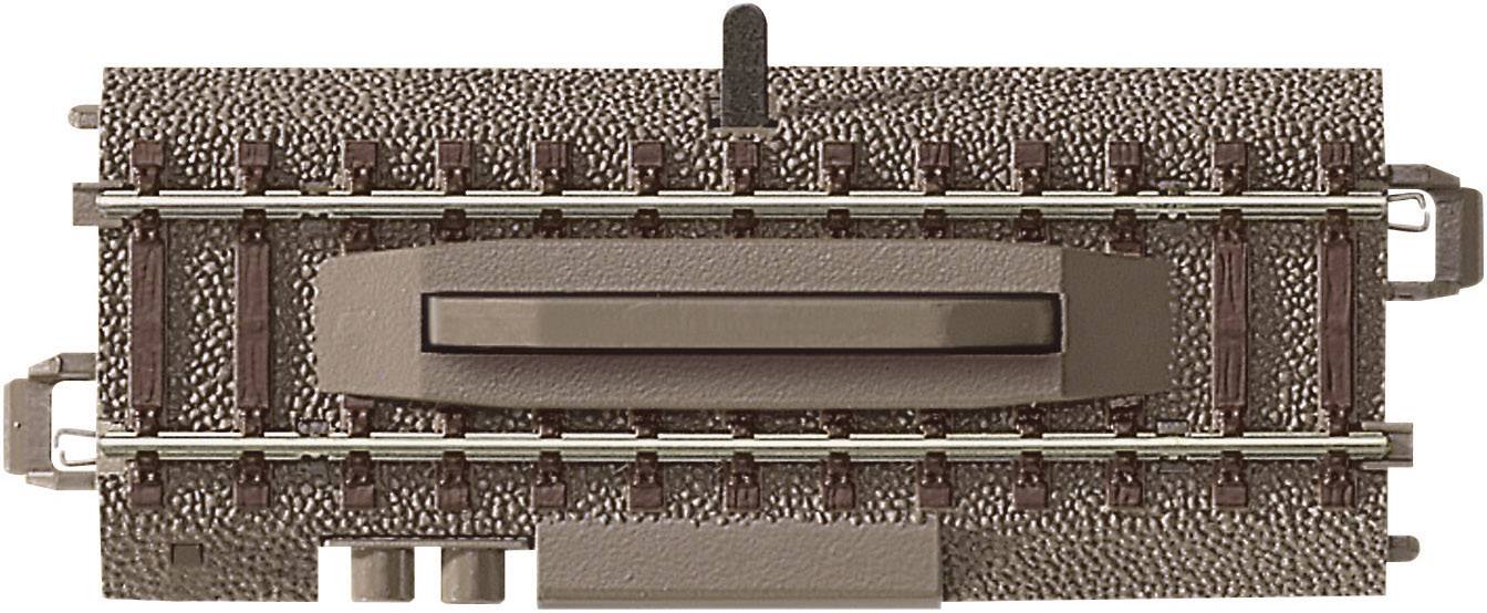 A section of model railway track with an integrated switch. The top surface shows a gravel bed and two sets of rails.