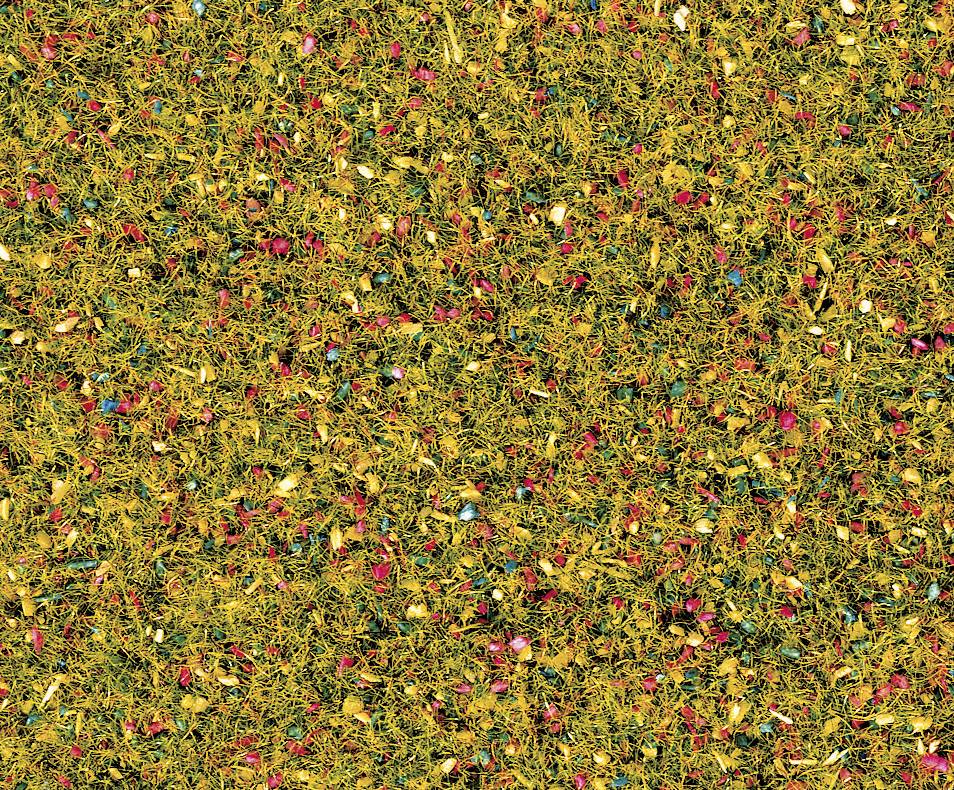 A carpet made of coloured, dried rice and spices, with yellow as the primary colour, complemented by red and blue accents.