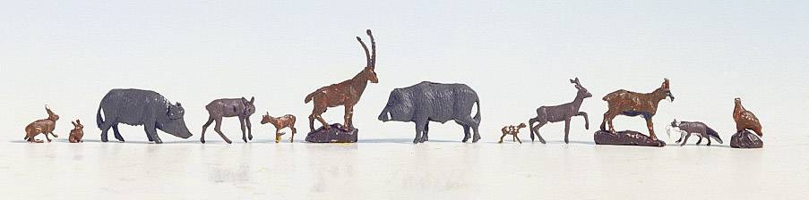 A series of metal animal figurines, including a wild boar, antelopes and hares, stand on a light surface.