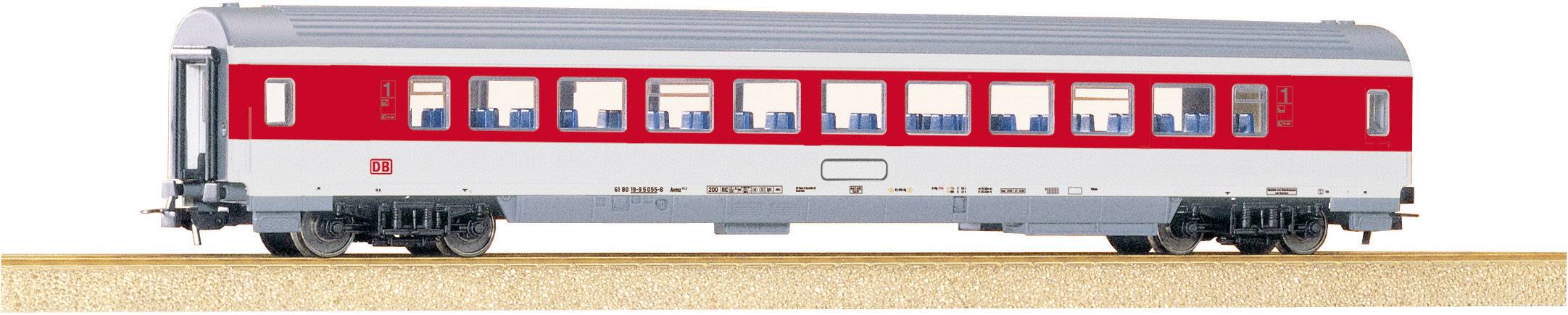 A model train carriage in red and white on a section of track. The carriage has numerous windows and blue seats inside.