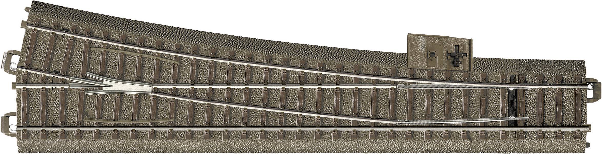 Railway point with two rail tracks, partially assembled, on a brown track bed.