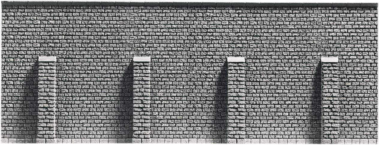 Brick wall with five buttresses, evenly distributed and arranged in parallel. Wall emphasised by shading.