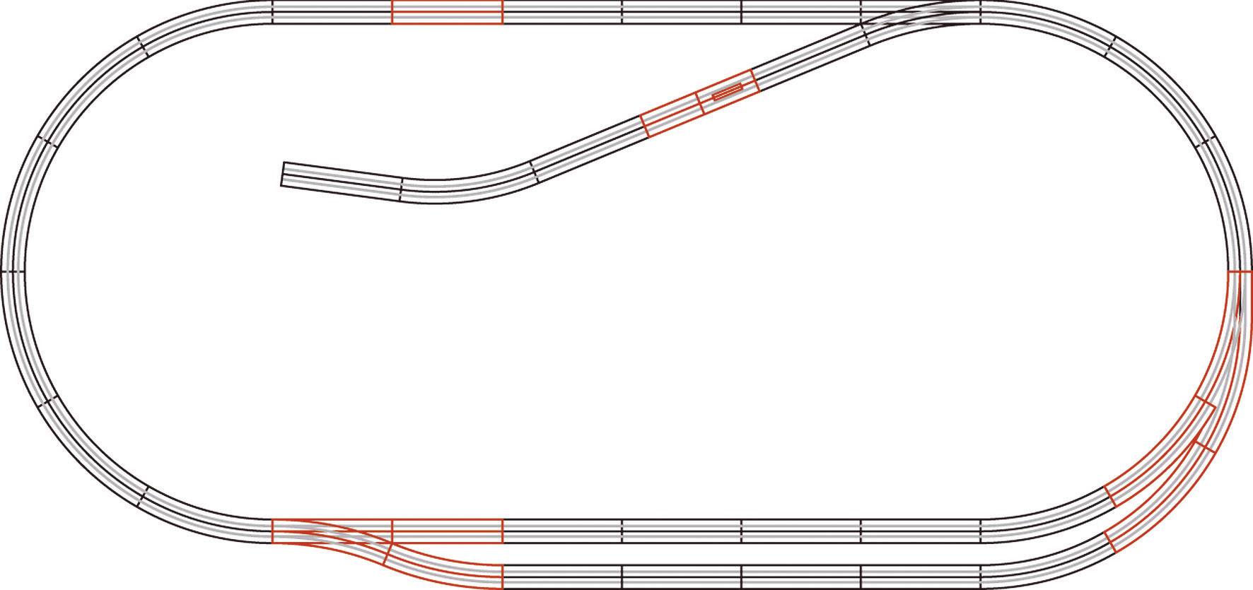 An oval model railway track with an additional loop and several points, shown from a top-down view.
