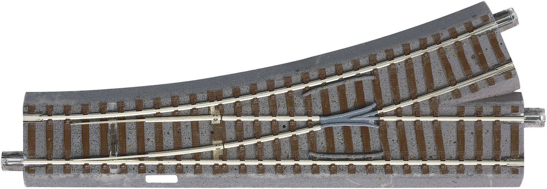 A curved model railway track section with a points/points switch provides direction and branching options for model trains.