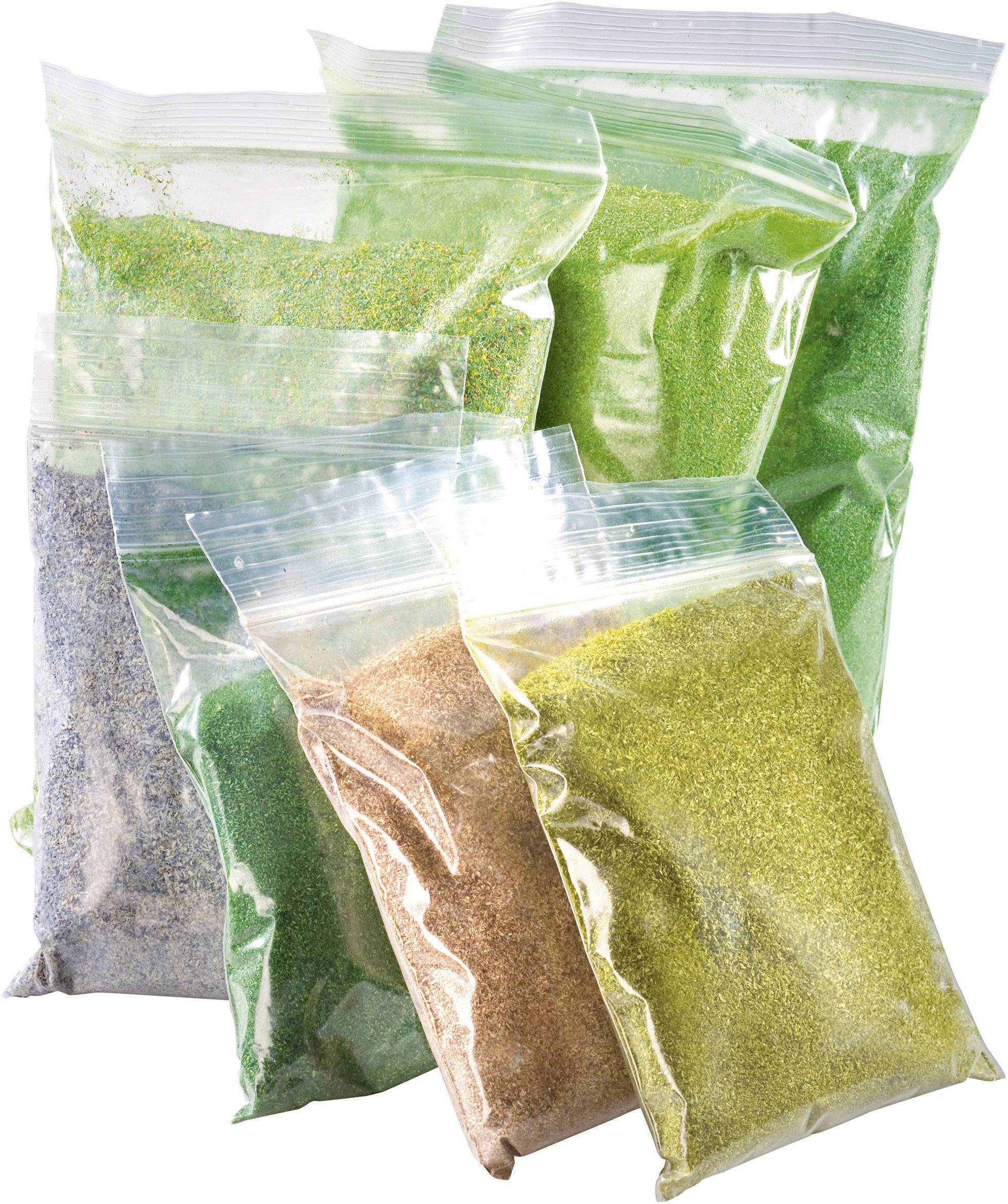 Several plastic bags filled with coloured sand in yellow, green, and brown shades, arranged vertically.