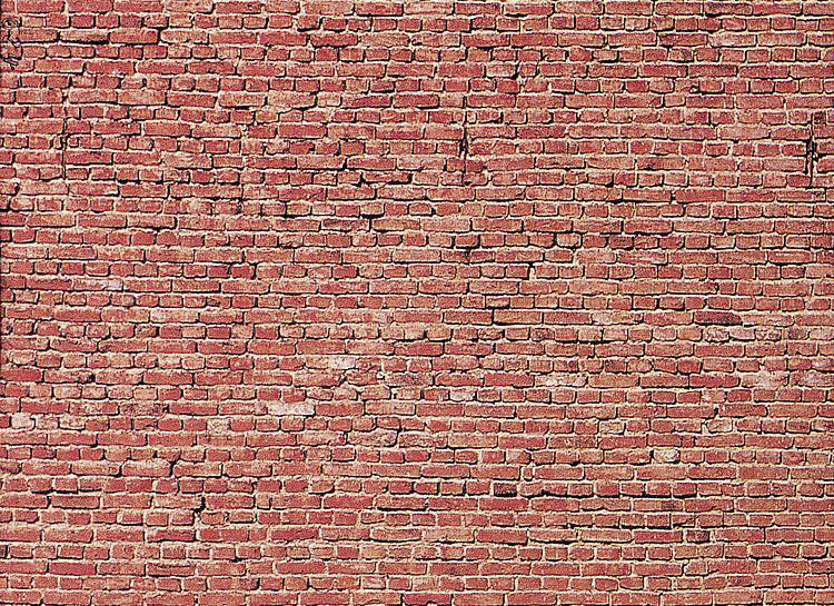A red brick wall with irregular mortar.