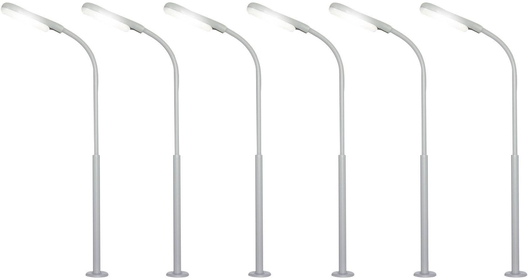 Five similar street lamps in a row, all shining brightly.