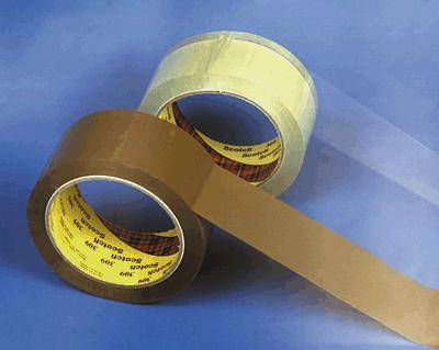 Two rolls of adhesive tape on a blue background, one transparent and the other brown, diagonally positioned.