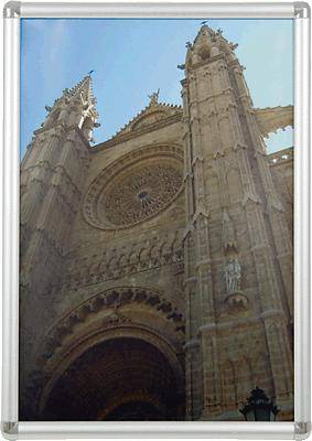 The facade of a Gothic cathedral with a large rose window and tall towers reaching into the sky.