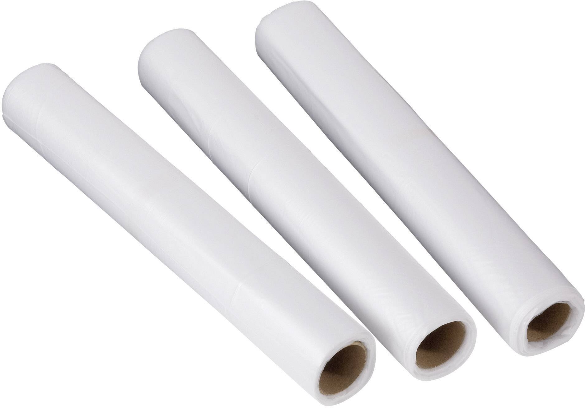 Three white plastic reels are lying side by side on a light background.