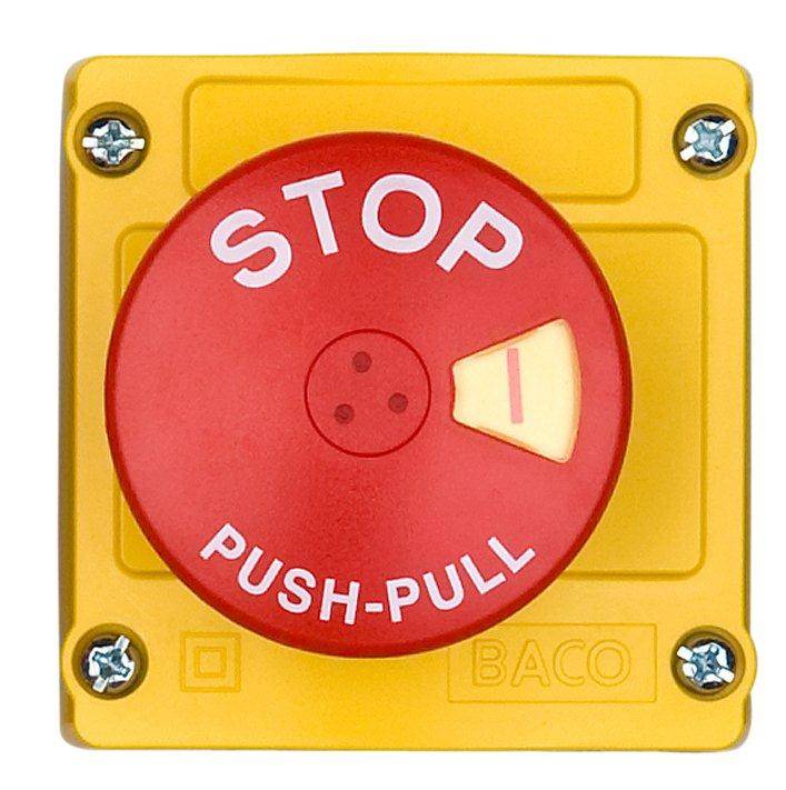 Red emergency stop switch with the inscription 'STOP PUSH-PULL' on a yellow base.