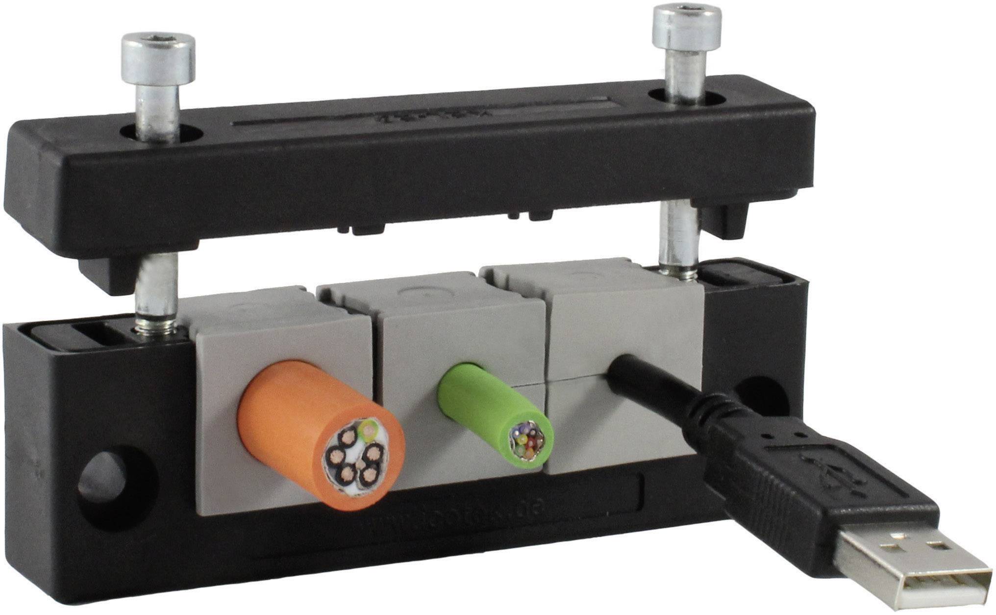 A cable routing system with multiple cables, including an orange and a green cable as well as a USB cable, which are guided through block-like mountings.