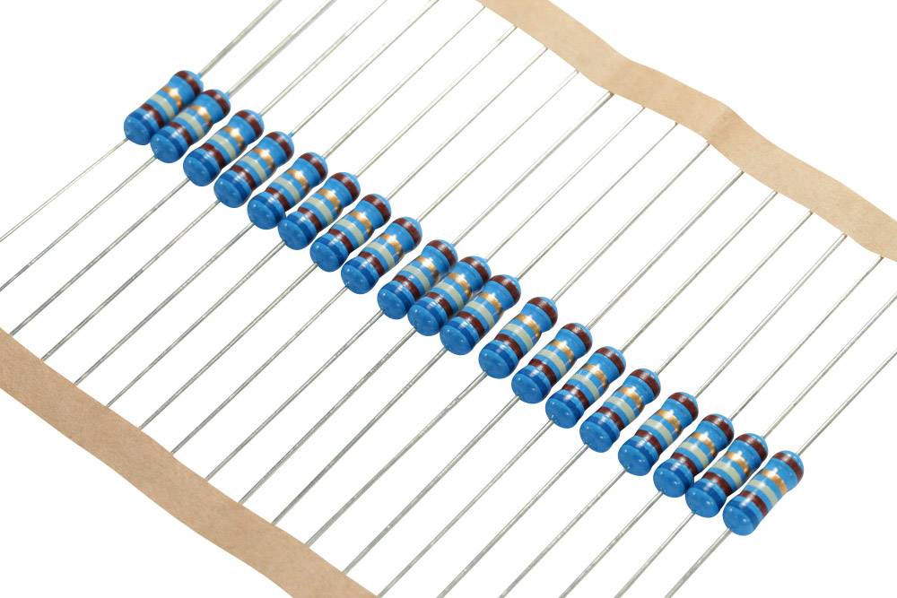 A row of blue resistors with colour rings arranged symmetrically on a white surface.