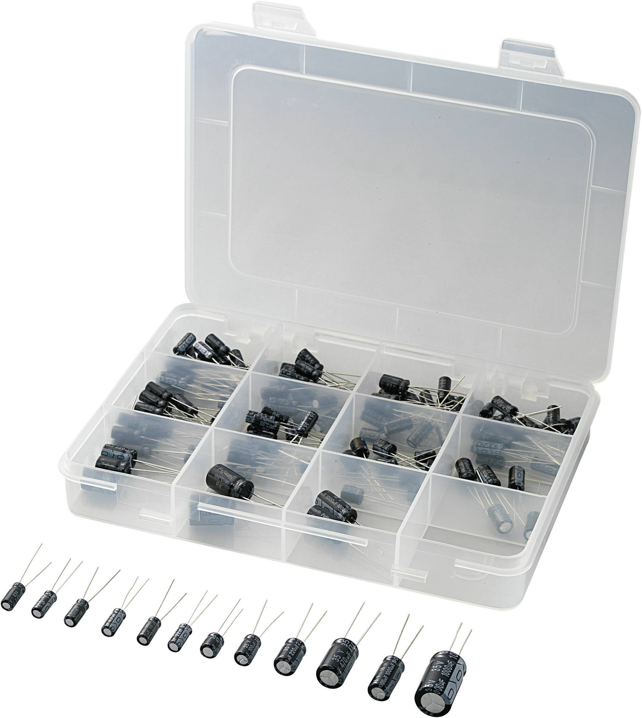 A transparent plastic box with multiple compartments containing different electronic components, primarily black capacitors.