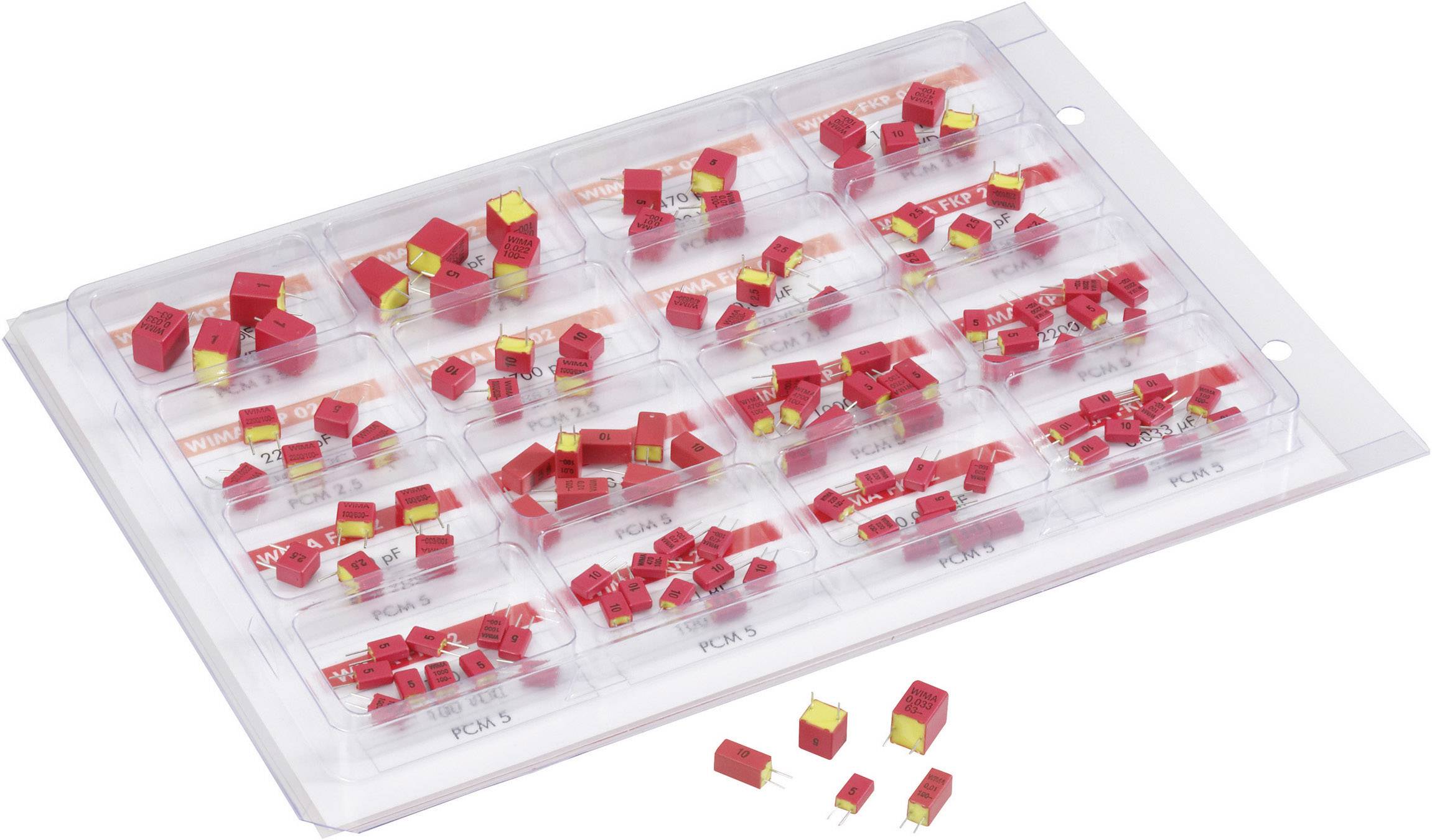 A multi-compartment packaging containing several small, red electronic components of varying sizes and shapes.